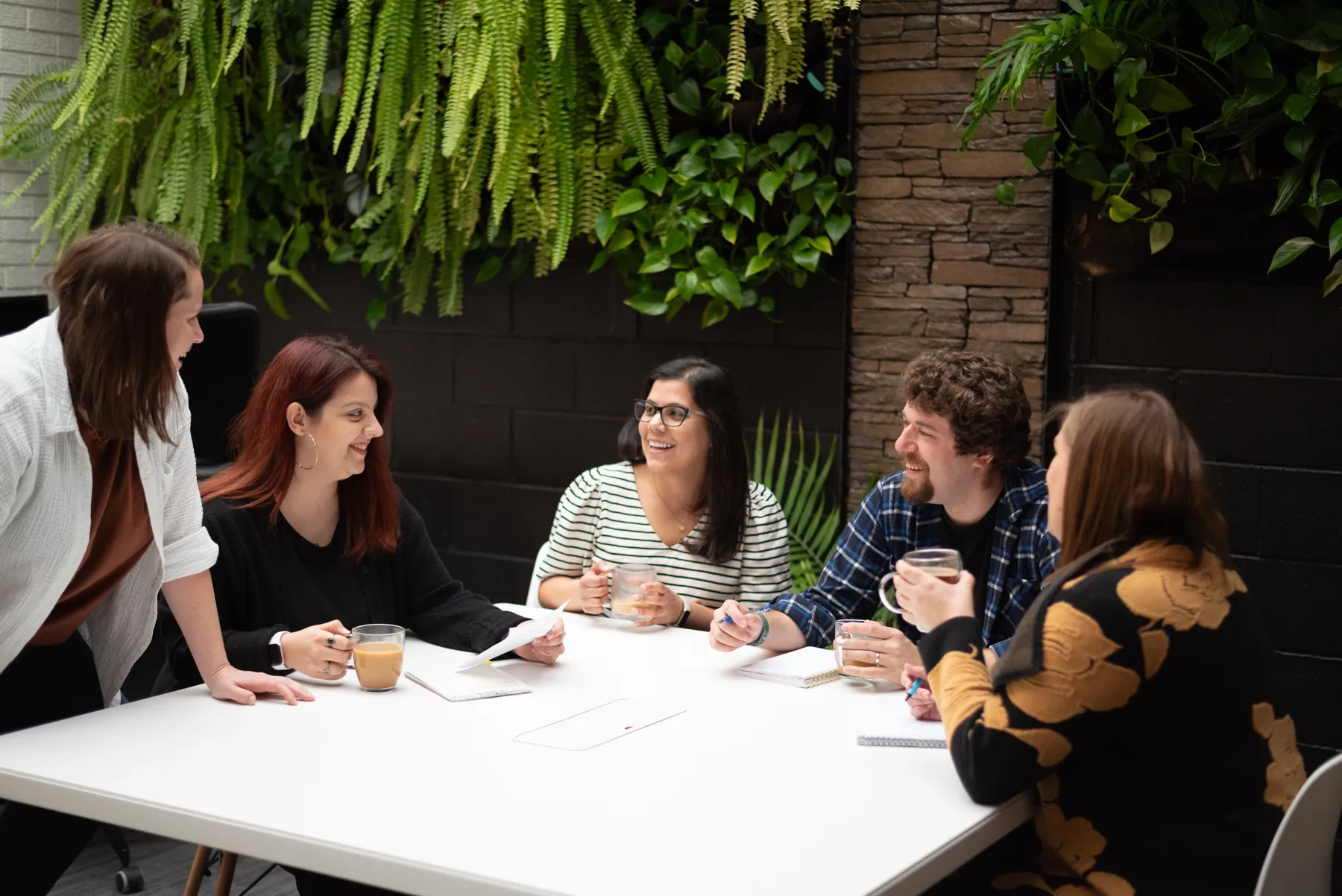 A team working through a plan around a table